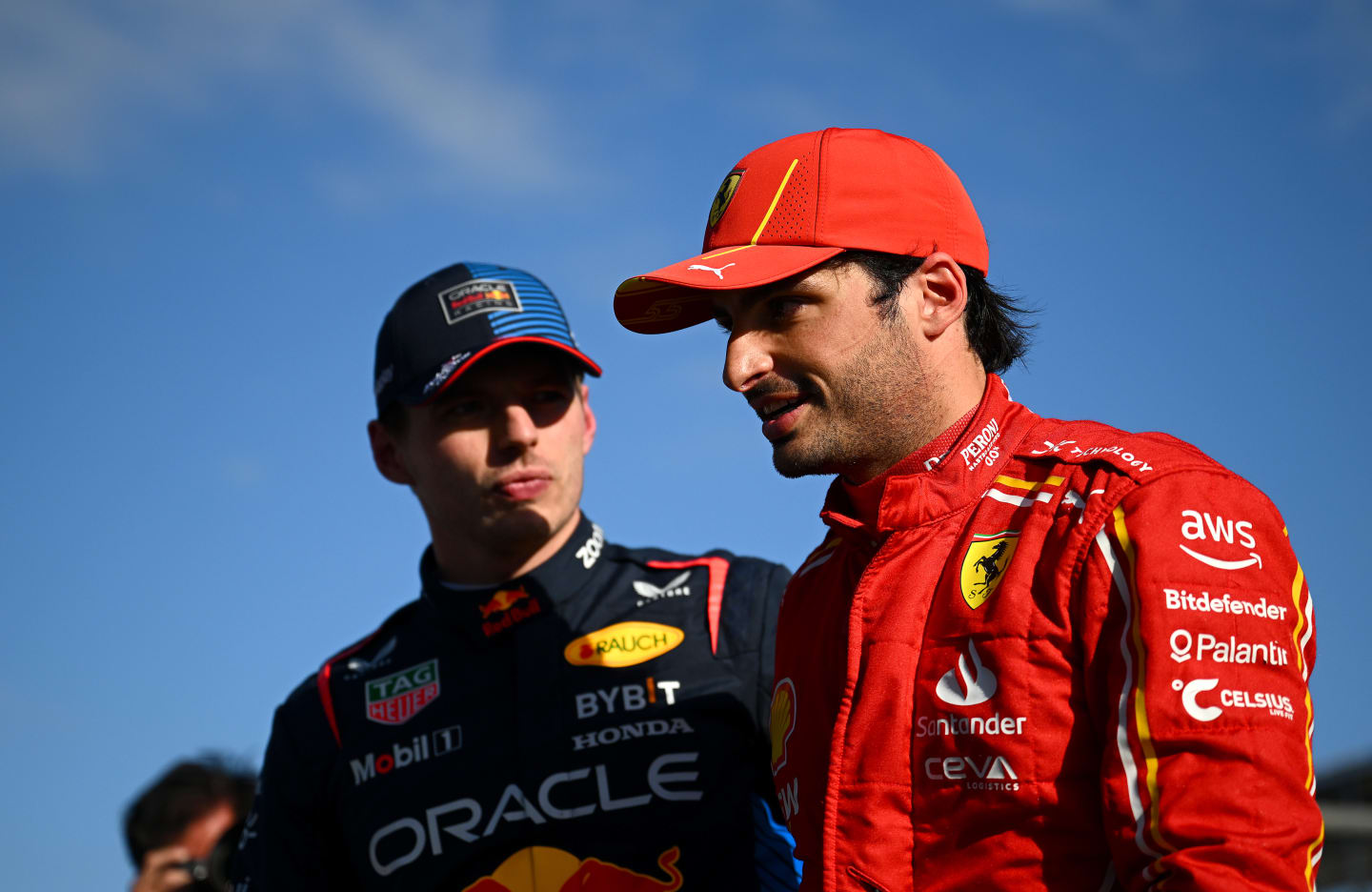 MELBOURNE, AUSTRALIA - MARCH 23: Second placed qualifier Carlos Sainz of Spain and Ferrari and Pole position qualifier Max Verstappen of the Netherlands and Oracle Red Bull Racing talk in parc ferme during qualifying ahead of the F1 Grand Prix of Australia at Albert Park Circuit on March 23, 2024 in Melbourne, Australia. (Photo by Clive Mason - Formula 1/Formula 1 via Getty Images)