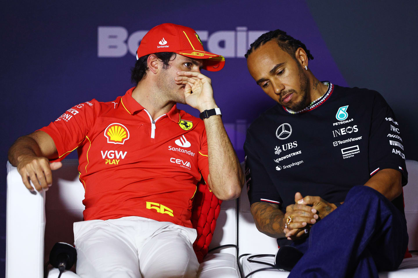 BAHRAIN, BAHRAIN - FEBRUARY 28: Carlos Sainz of Spain and Ferrari and Lewis Hamilton of Great Britain and Mercedes attend the Drivers Press Conference during previews ahead of the F1 Grand Prix of Bahrain at Bahrain International Circuit on February 28, 2024 in Bahrain, Bahrain. (Photo by Clive Rose/Getty Images)