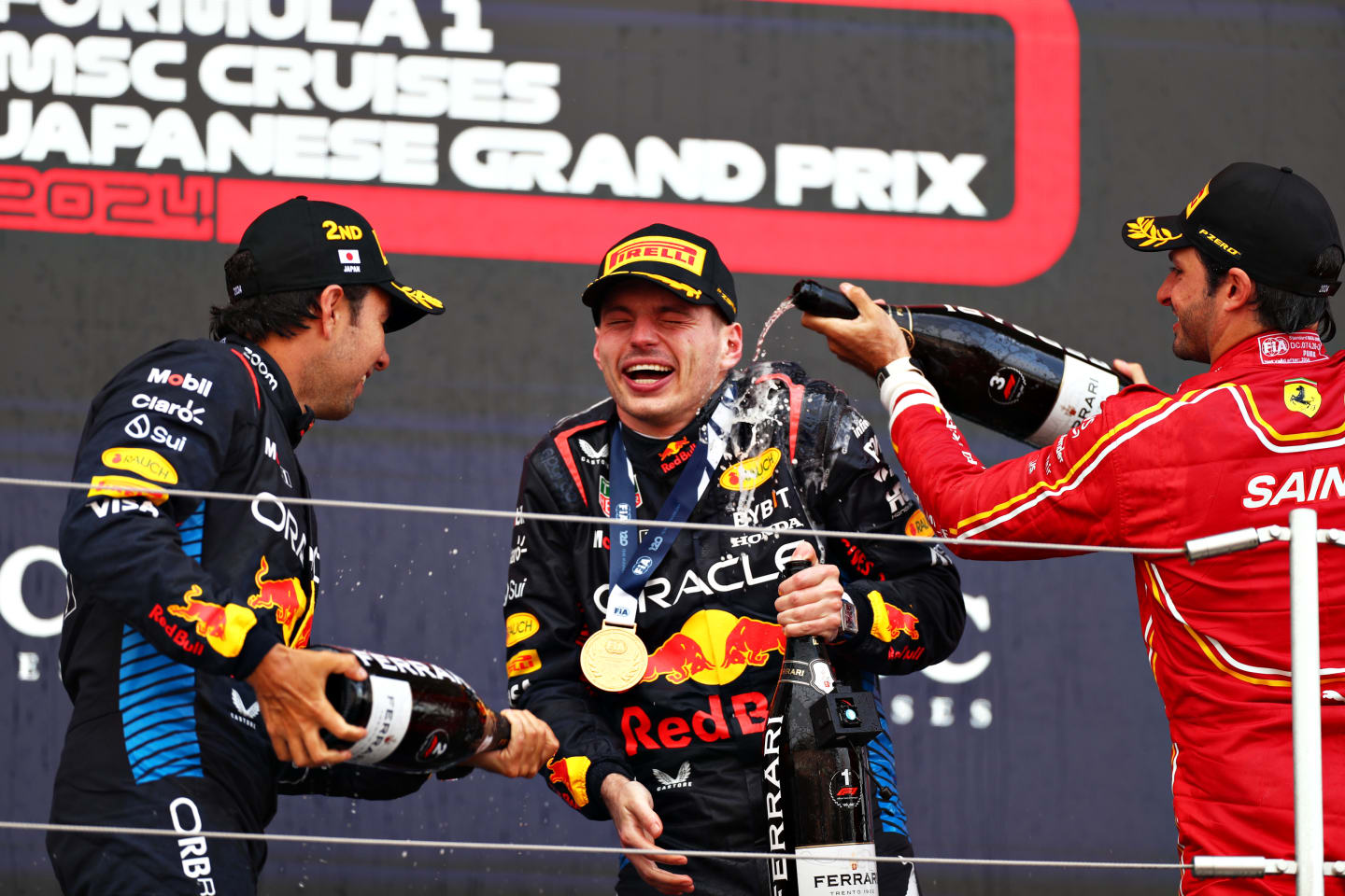 SUZUKA, JAPAN - APRIL 07: Race winner Max Verstappen of the Netherlands and Oracle Red Bull Racing, Second placed Sergio Perez of Mexico and Oracle Red Bull Racing and Third placed Carlos Sainz of Spain and Ferrari celebrate on the podium during the F1 Grand Prix of Japan at Suzuka International Racing Course on April 07, 2024 in Suzuka, Japan. (Photo by Peter Fox/Getty Images)