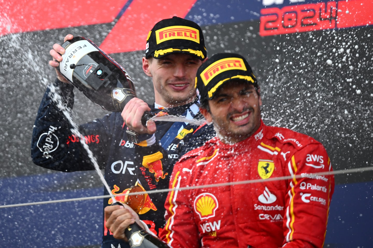 SUZUKA, JAPAN - APRIL 07: Race winner Max Verstappen of the Netherlands and Oracle Red Bull Racing and Third placed Carlos Sainz of Spain and Ferrari celebrate on the podium during the F1 Grand Prix of Japan at Suzuka International Racing Course on April 07, 2024 in Suzuka, Japan. (Photo by Clive Mason/Getty Images)