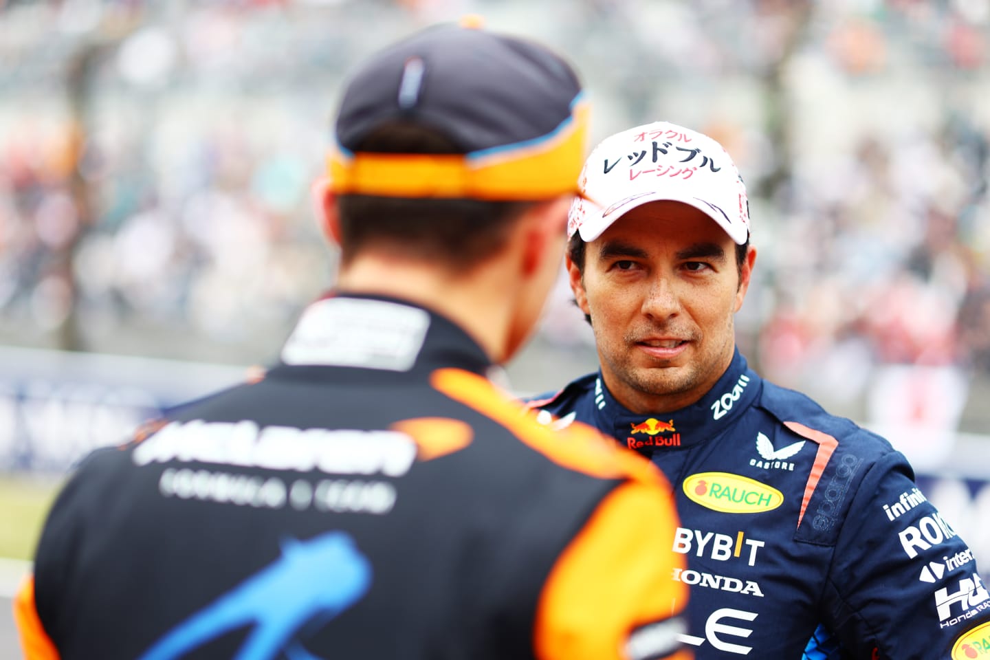 SUZUKA, JAPAN - APRIL 06: Second placed qualifier Sergio Perez of Mexico and Oracle Red Bull Racing talks with Third placed qualifier Lando Norris of Great Britain and McLaren in parc ferme during qualifying ahead of the F1 Grand Prix of Japan at Suzuka International Racing Course on April 06, 2024 in Suzuka, Japan. (Photo by Mark Thompson/Getty Images)