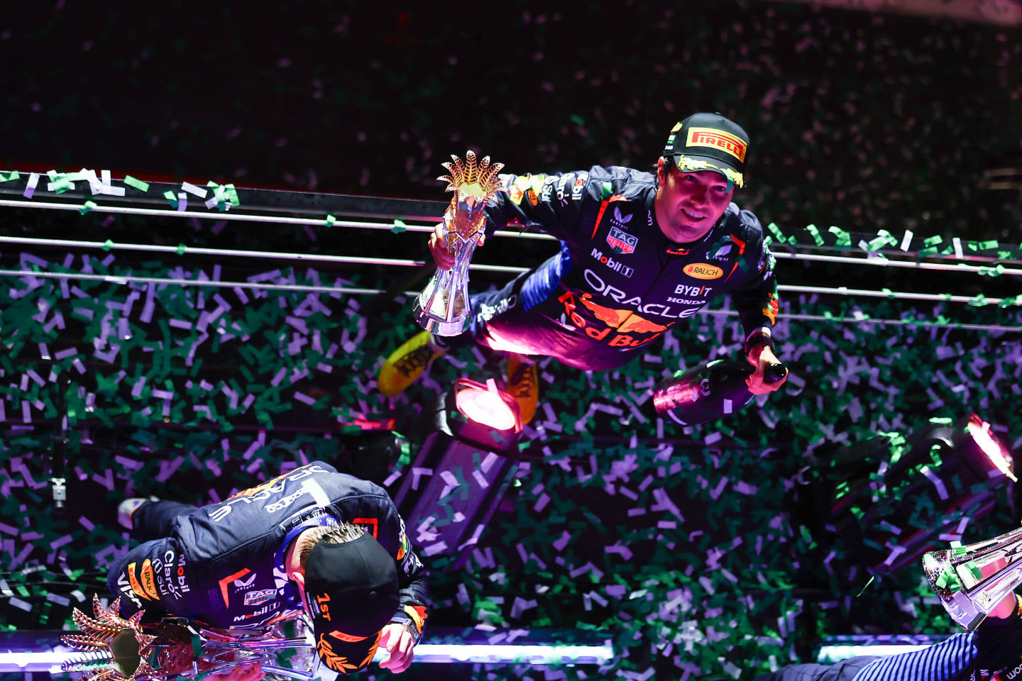JEDDAH, SAUDI ARABIA - MARCH 09: Second placed Sergio Perez of Mexico and Oracle Red Bull Racing celebrates on the podium during the F1 Grand Prix of Saudi Arabia at Jeddah Corniche Circuit on March 09, 2024 in Jeddah, Saudi Arabia. (Photo by Mark Thompson/Getty Images)