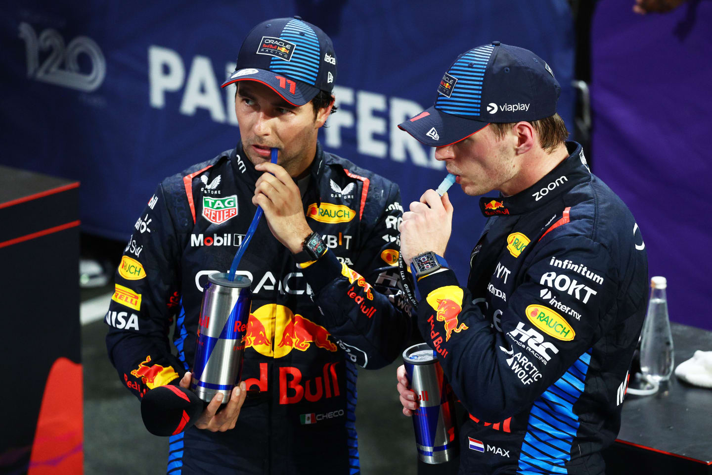 JEDDAH, SAUDI ARABIA - MARCH 09: Second placed Sergio Perez of Mexico and Oracle Red Bull Racing and Race winner Max Verstappen of the Netherlands and Oracle Red Bull Racing react in parc ferme during the F1 Grand Prix of Saudi Arabia at Jeddah Corniche Circuit on March 09, 2024 in Jeddah, Saudi Arabia. (Photo by Clive Rose/Getty Images)