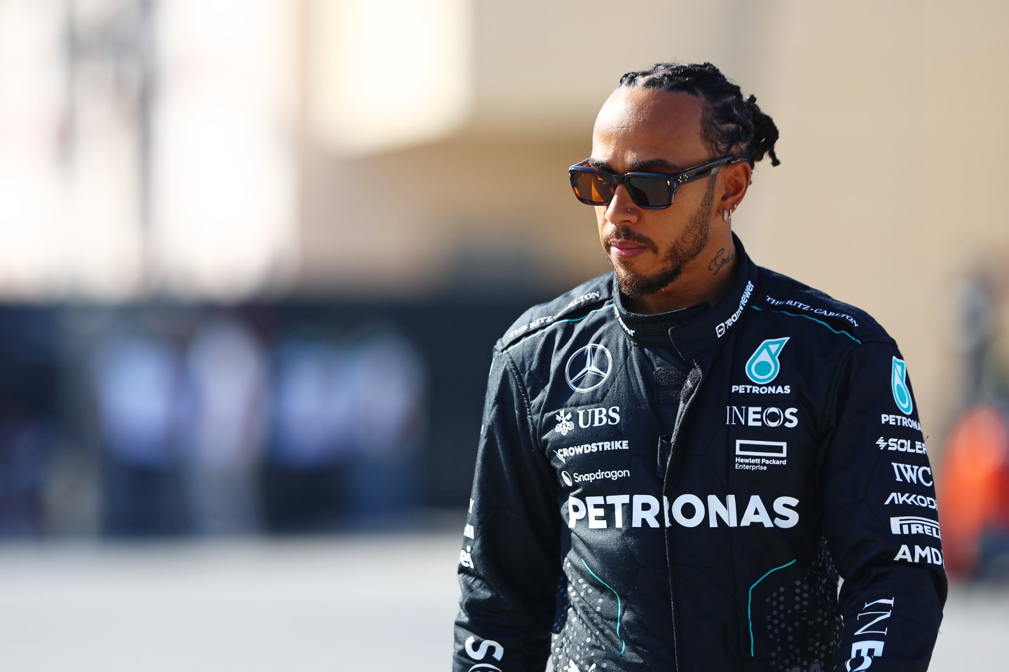 BAHRAIN, BAHRAIN - FEBRUARY 21: Lewis Hamilton of Great Britain and Mercedes walks in the Paddock