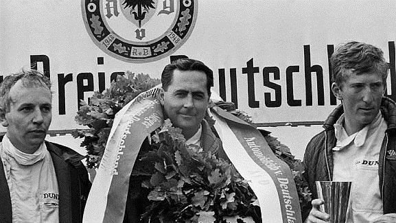 The podium (L to R): John Surtees (GBR) Cooper second; Jack Brabham (AUS) Brabham race winner; Jochen Rindt (AUT) Cooper third. German Grand Prix, Nurburgring, 7 August 1966. World © Phipps/Sutton. © Sutton Images