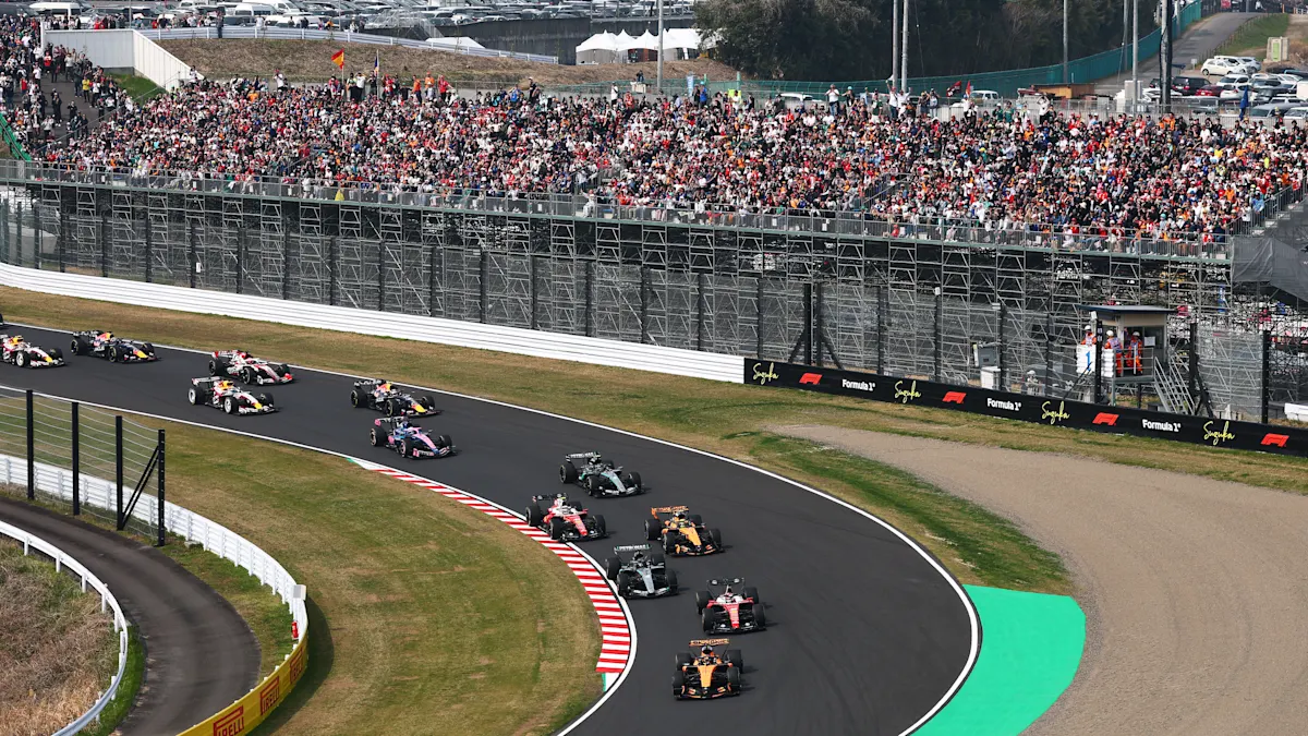 McLaren and Mercedes and Ferrari Formula 1 cars on track at Suzuka Circuit