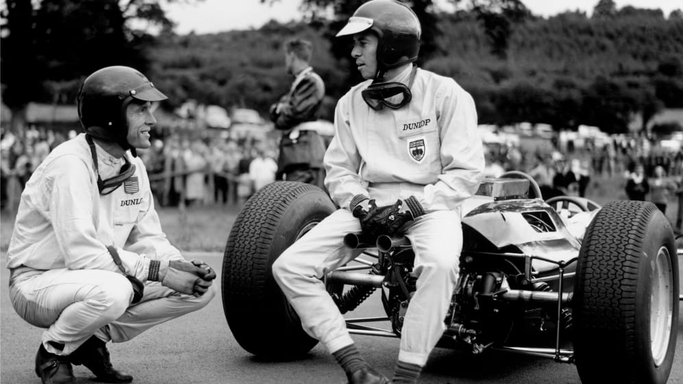 Spa-Francorchamps, Belgium. 12-14 June 1964.rJim Clark (Lotus 25-Climax) talks to Dan Gurney