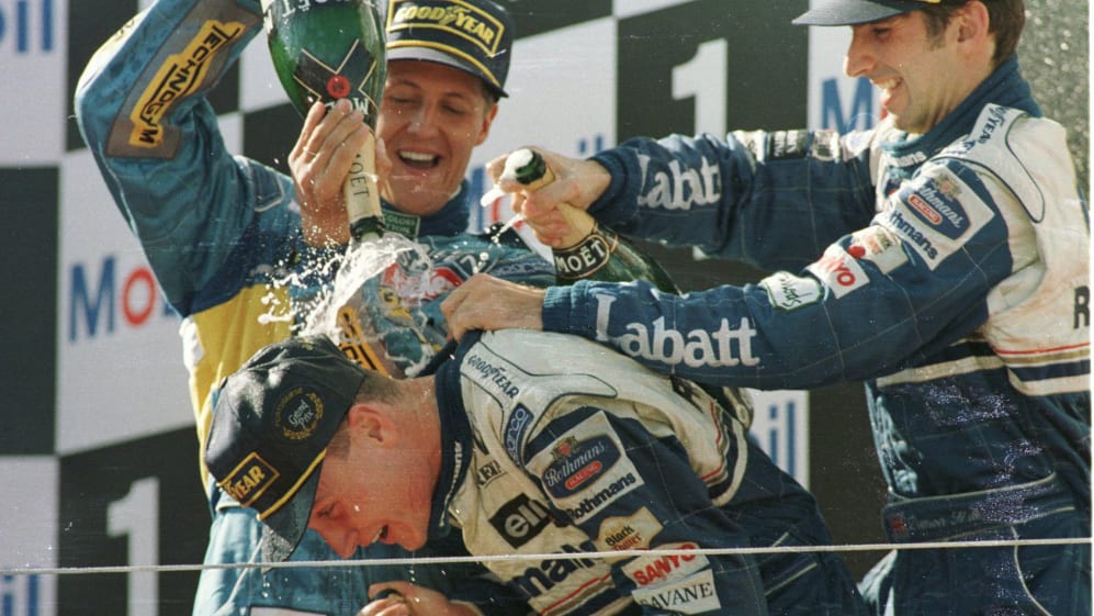 Damon Hill (R) and Michael Schumacher (L, top) celebrate with race winner Coulthard at Estoril in 1994