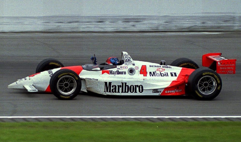 INDIANAPOLIS, IN - MAY 30:  Brazilian driver Emerson Fittipaldi salutes the crowd as he drives