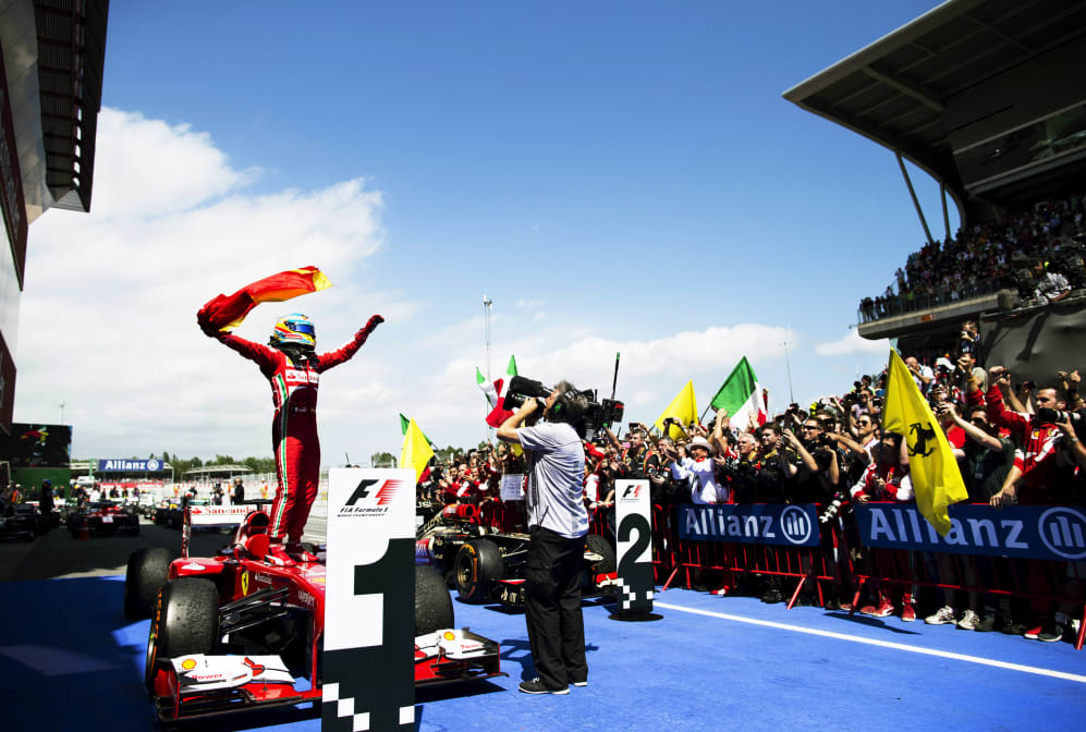 Spanish Scuderia Ferrari Formula One racing team racing driver Fernando Alonso standing on his F138