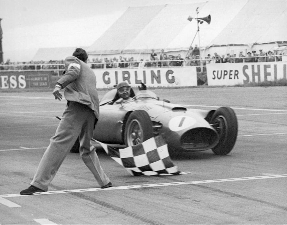 UNITED KINGDOM - AUGUST 14:  Juan FANGIO crossing the finish line first in his FERRARI at the