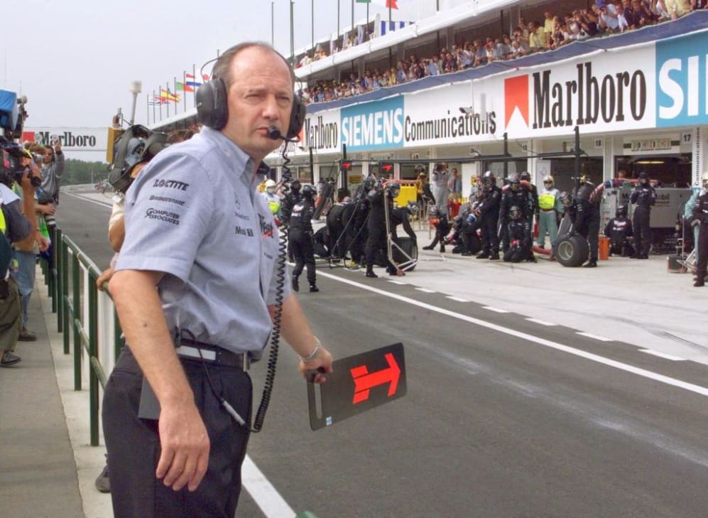 McLaren-Mercedes team manager Ron Dennis shows his Finnish driver Mika Hakkinen a placard