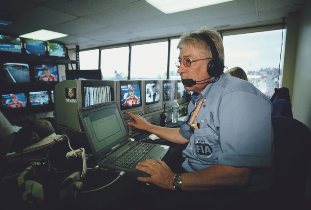 Herbie Blash of Great Britain, FIA Deputy Race Director sits in front of the monitors in Race