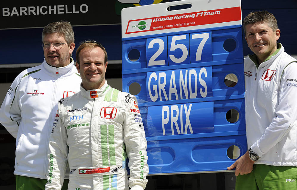 Honda's Brazilian driver Rubens Barrichello (C) poses with Honda's team boss Ross Brawn (L) and
