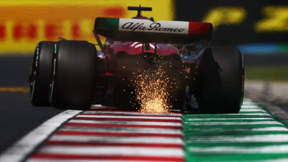 BUDAPEST, HUNGARY - JULY 22: Sparks fly behind Valtteri Bottas of Finland driving the (77) Alfa