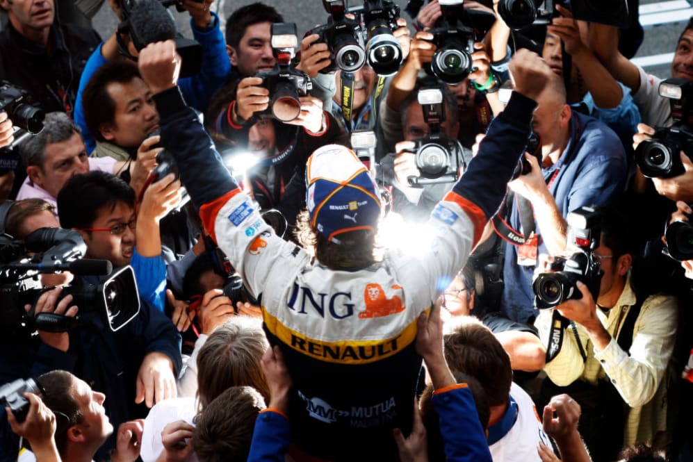 Spanish Renault Formula One driver Fernando Alonso is held aloft by his Renault mechanics in