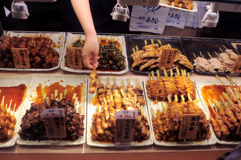 TOKYO, JAPAN - JANUARY 16, 2014: Sticks of grilled chicken (yakitori) for sale at a food store in