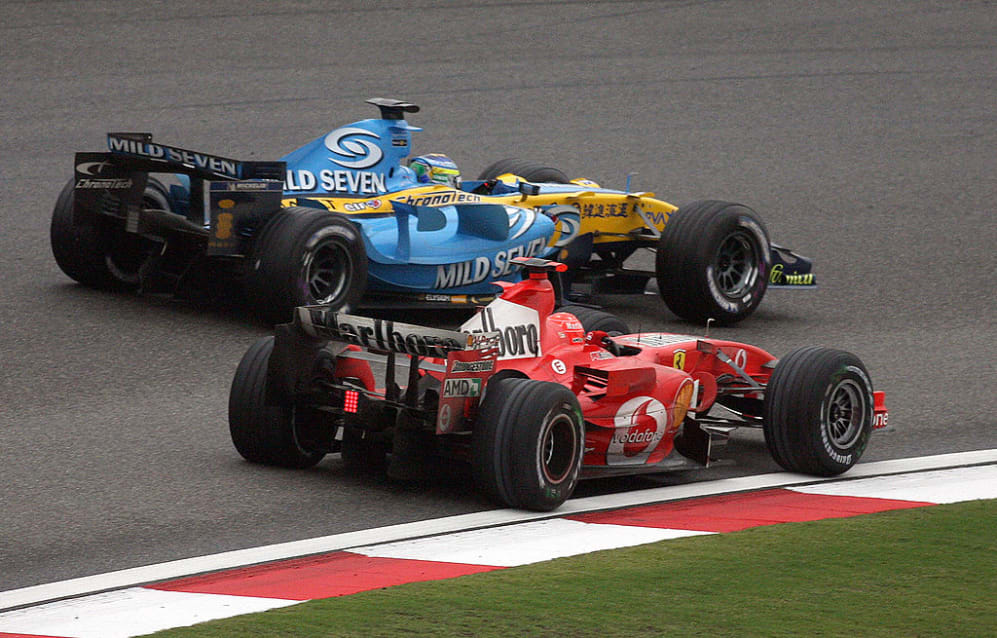 Shanghai, CHINA:  Ferrari driver Michael Schumacher (front) of Germany overtakes Renault driver