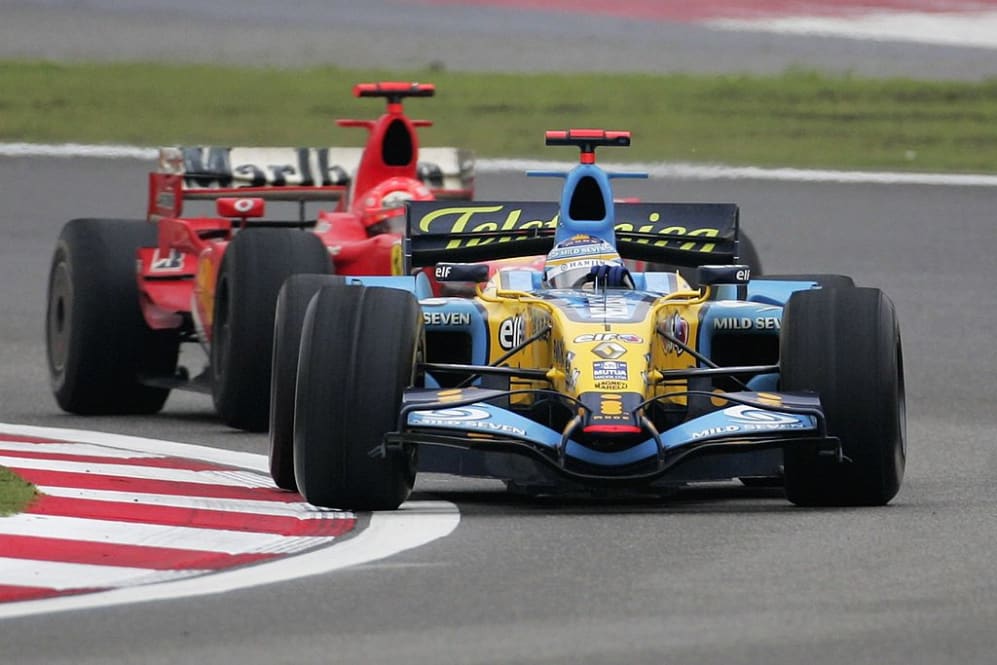 SHANGHAI, CHINA - OCTOBER 01:  Fernando Alonso of Spain and Renault leads Michael Schumacher of