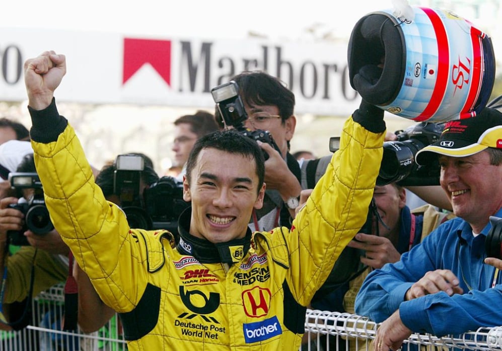 Takuma Sato of Japan raises his arms as he celebrates his performance in a home circuit after the