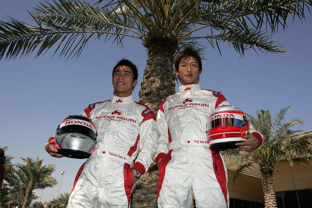 SAKHIR, BAHRAIN - MARCH 09:  Takuma Sato and Yugi Ide of Japan and Super Aguri F1 pose for