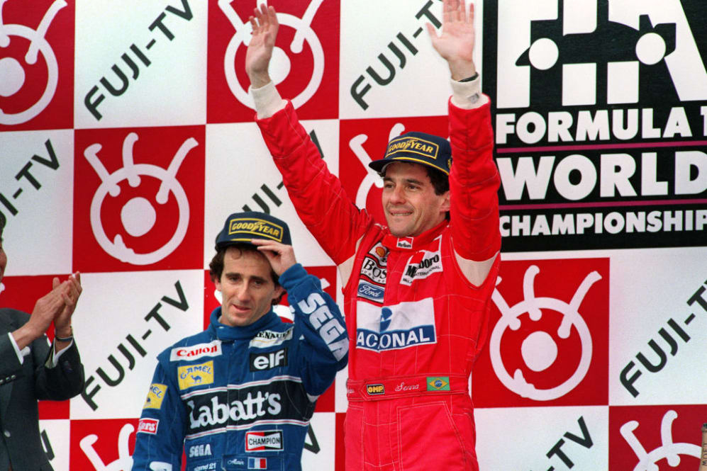 Three times world champion Ayrton Senna (R) of Brazil waves on the podium after winnng the Japanese