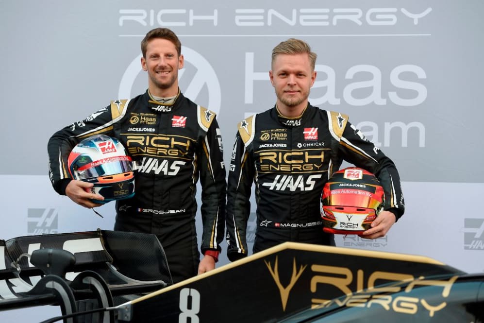 Haas French driver Romain Grosjean (L) and Haas Danish driver Kevin Magnussen pose after unveiling