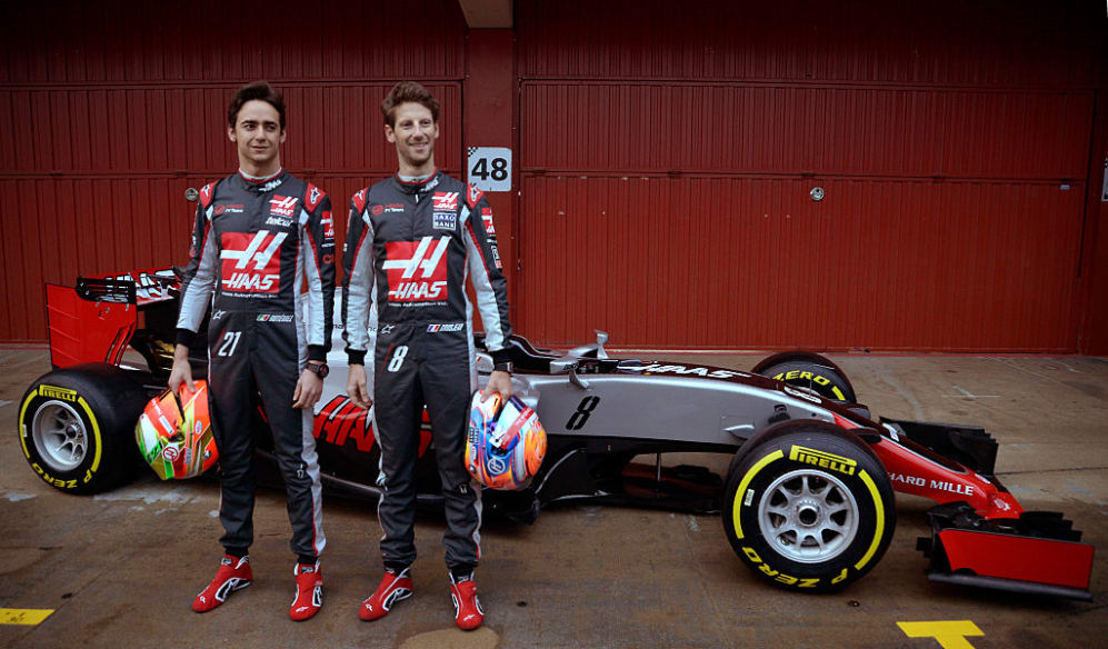 HAAS F1 team Mexican driver Esteban Gutierrez (L) and Swiss pilot Romain Grosjean pose by their new