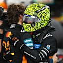 ABU DHABI, UNITED ARAB EMIRATES - DECEMBER 07: 2025 F1 World Drivers Champion and Third placed Lando Norris of Great Britain and McLaren celebrates in parc ferme with Second placed Oscar Piastri of Australia and McLaren during the F1 Grand Prix of Abu Dhabi at Yas Marina Circuit on December 07, 2025 in Abu Dhabi, United Arab Emirates. (Photo by Clive Rose/Getty Images)