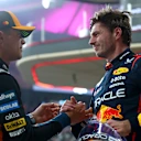 ABU DHABI, UNITED ARAB EMIRATES - DECEMBER 06: Pole position qualifier Max Verstappen of the Netherlands and Oracle Red Bull Racing and Second placed qualifier Lando Norris of Great Britain and McLaren congratulate each other in parc ferme during qualifying ahead of the F1 Grand Prix of Abu Dhabi at Yas Marina Circuit on December 06, 2025 in Abu Dhabi, United Arab Emirates. (Photo by Bryn Lennon - Formula 1/Formula 1 via Getty Images)