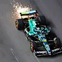 LAS VEGAS, NEVADA - NOVEMBER 20: Sparks fly behind Lance Stroll of Canada driving the (18) Aston Martin F1 Team AMR25 Mercedes on track during practice ahead of the F1 Grand Prix of Las Vegas at Las Vegas Strip Circuit on November 20, 2025 in Las Vegas, Nevada. (Photo by Clive Mason/Getty Images)