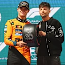 LAS VEGAS, NEVADA - NOVEMBER 21: Pole position qualifier Lando Norris of Great Britain and McLaren receives his Pirelli Pole Position award from Louis Tomlinson during qualifying ahead of the F1 Grand Prix of Las Vegas at Las Vegas Strip Circuit on November 21, 2025 in Las Vegas, Nevada. (Photo by Bryn Lennon - Formula 1/Formula 1 via Getty Images)