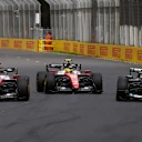 MELBOURNE, AUSTRALIA - MARCH 08: Charles Leclerc of Monaco driving the (16) Scuderia Ferrari SF-26 Lewis Hamilton of Great Britain driving the (44) Scuderia Ferrari SF-26 and George Russell of Great Britain driving the (63) Mercedes AMG Petronas F1 Team W17 battle for the lead during the F1 Grand Prix of Australia at Albert Park Grand Prix Circuit on March 08, 2026 in Melbourne, Australia. (Photo by Joe Portlock/Getty Images)