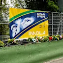 Bouquets of flowers are laid on the Tamburello wall where the Brazilian champion died during the event on May 1