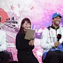 RB's Japanese driver Yuki Tsunoda (L) and his Australian teammate Daniel Ricciardo (R) attend a