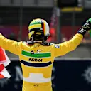 IMOLA, ITALY - MAY 19: Sebastian Vettel holds an Austrian and Brazilian flag in tribute to Roland