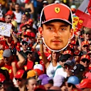 Ferrari pride on full display. A dedicated supporter raises the flag high for Charles Leclerc.