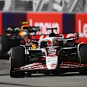 SINGAPORE, SINGAPORE - OCTOBER 05: Esteban Ocon of France driving the (31) Haas F1 VF-25 Ferrari leads Yuki Tsunoda of Japan driving the (22) Oracle Red Bull Racing RB21 on track during to the F1 Grand Prix of Singapore at Marina Bay Street Circuit on October 05, 2025 in Singapore, Singapore. (Photo by Clive Mason/Getty Images)