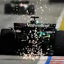 SINGAPORE, SINGAPORE - OCTOBER 05: Sparks fly behind Lance Stroll of Canada driving the (18) Aston Martin F1 Team AMR25 Mercedes on track during the F1 Grand Prix of Singapore at Marina Bay Street Circuit on October 05, 2025 in Singapore, Singapore. (Photo by Mark Sutton - Formula 1/Formula 1 via Getty Images)