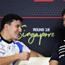 SINGAPORE, SINGAPORE - OCTOBER 02: Isack Hadjar of France and Visa Cash App Racing Bulls talks with Alexander Albon of Thailand and Williams in the Drivers Press Conference during previews ahead of the F1 Grand Prix of Singapore at Marina Bay Street Circuit on October 02, 2025 in Singapore, Singapore. (Photo by Bryn Lennon/Getty Images)