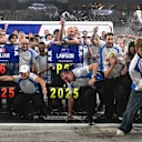 ABU DHABI, UNITED ARAB EMIRATES - DECEMBER 07: Isack Hadjar of France and Visa Cash App Racing Bulls Alan Permane, Team Principal of Visa Cash App Racing Bulls Liam Lawson of New Zealand and Visa Cash App Racing Bulls and the Visa Cash App Racing Bulls team celebrate during the F1 Grand Prix of Abu Dhabi at Yas Marina Circuit on December 07, 2025 in Abu Dhabi, United Arab Emirates. (Photo by Rudy Carezzevoli/Getty Images)