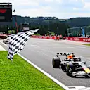 SPA, BELGIUM - JULY 26: Sprint winner Max Verstappen of the Netherlands driving the (1) Oracle Red Bull Racing RB21 takes the chequered flag waved by Thibaut Courtois during the Sprint ahead of the F1 Grand Prix of Belgium at Circuit de Spa-Francorchamps on July 26, 2025 in Spa, Belgium. (Photo by Mark Sutton - Formula 1/Formula 1 via Getty Images)