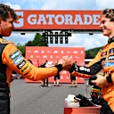 SPA, BELGIUM - JULY 26: Second placed Oscar Piastri of Australia and McLaren and Third placed Lando Norris of Great Britain and McLaren congratulate each other in parc ferme during the Sprint ahead of the F1 Grand Prix of Belgium at Circuit de Spa-Francorchamps on July 26, 2025 in Spa, Belgium. (Photo by Mark Sutton - Formula 1/Formula 1 via Getty Images)