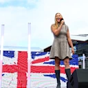 Becky Hill performs the national anthem ahead of the race
