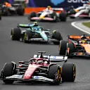 BUDAPEST, HUNGARY - AUGUST 03: Charles Leclerc of Monaco driving the (16) Scuderia Ferrari SF-25 leads Oscar Piastri of Australia driving the (81) McLaren MCL39 Mercedes and Fernando Alonso of Spain driving the (14) Aston Martin F1 Team AMR25 Mercedes at the start during the F1 Grand Prix of Hungary at Hungaroring on August 03, 2025 in Budapest, Hungary. (Photo by James Sutton - Formula 1/Formula 1 via Getty Images)