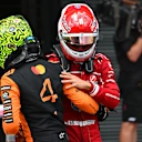 BUDAPEST, HUNGARY - AUGUST 02: Pole position qualifier Charles Leclerc of Monaco and Scuderia Ferrari and Third placed qualifier Lando Norris of Great Britain and McLaren congratulate each other in parc ferme during qualifying ahead of the F1 Grand Prix of Hungary at Hungaroring on August 02, 2025 in Budapest, Hungary. (Photo by Rudy Carezzevoli/Getty Images)