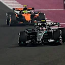 LUSAIL CITY, QATAR - NOVEMBER 30: Andrea Kimi Antonelli of Italy driving the (12) Mercedes AMG Petronas F1 Team W16 leads Lando Norris of Great Britain driving the (4) McLaren MCL39 Mercedes on track during the F1 Grand Prix of Qatar at Lusail International Circuit on November 30, 2025 in Lusail City, Qatar. (Photo by Clive Mason/Getty Images)
