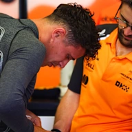 BARCELONA, SPAIN - MAY 30: Lando Norris of Great Britain and McLaren attaches a cooling vest in the