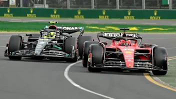 Ferrari's Monegasque driver Charles Leclerc (R) and Mercedes' British driver Lewis Hamilton drive