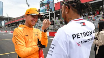 McLaren's British driver Lando Norris and Mercedes' British driver Lewis Hamilton attend the